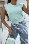 Short pastel green sleeveless sweater with a round neck.