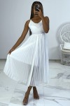 White dress with accordion-style pleated skirt.