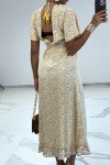 Long beige Liberty print dress with slit and flounce.