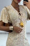 Long beige Liberty print dress with slit and flounce.