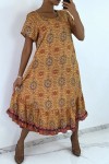 Long mustard dress with short sleeves and colorful print.