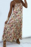 Long, flowing beige dress with colorful prints and thin straps.