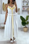 Long white dress with yellow embroidery and pompom.