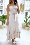 Long beige dress with buttoned straps with belt and ruffles.