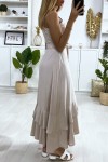 Long beige dress with buttoned straps with belt and ruffles.