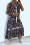 Long black patterned dress with accessory and pompom.