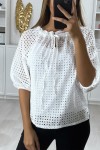 White blouse for women puffed sleeves boat neck in material with holes.