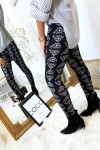Black winter leggings with white tiger head patterns.