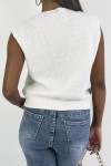 White sleeveless V-neck sweater with pretty braided pattern.