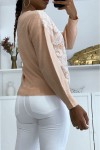 Pastel pink V-neck sweater with white lace pattern.