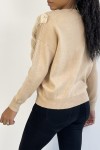 Beige sweater with round neck and faux fur and rhinestone pattern.