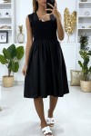 Flared black dress with pearls and elastic at the bust