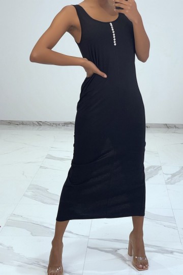 Long fluid black dress with button on the front and slit on the back.