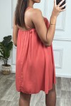Short flowing and flared coral dress with thin straps.