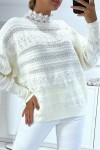 White openwork sweater with round neck and lace.