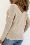Shiny pink V-neck sweater with openwork line detail.