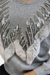 Gray sweater with round neck and faux fur and rhinestone pattern.