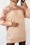 Long pink turtleneck sweater with openwork embroidery details.