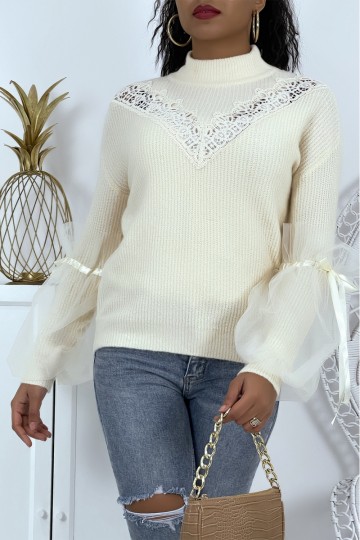 Beige high neck sweater with puffed sleeves in tulle.
