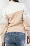 Loose-fitting powder pink and white two-tone short sweater with high collar and lace veil at the chest.
