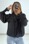 Classic style black blouse with ruffles and puff sleeves.