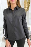 Women's shirt in black with bands and pearls on the sleeves.