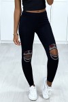 Women's black cotton leggings with openings and rhinestones at the knees.