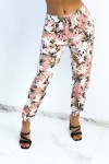 Flowing pink pants with tropical print tightened at the ankles
