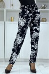 Fluid cigarette pants in navy blue with a floral print.