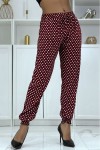 Flowing burgundy pants with polka dots and elastic ankles