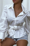 White shirt with puff sleeves and integrated belt.