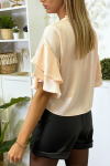 Pink crepe blouse with ruffles on the sleeves.