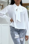 Flowing white blouse with long sleeves