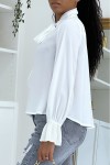 Flowing white blouse with long sleeves
