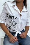 Long-sleeved white shirt with design and inscription.