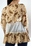 Bohemian-style openwork tunic with pompoms and patterns.