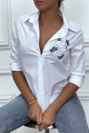 White long-sleeved shirt with print.