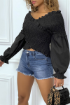Black pleated blouse with long puffed sleeves.