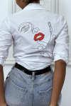 Fitted white shirt with design on the back.