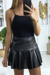Flared black faux leather mini skirt with back closure.
