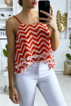 Tank top with red and white pattern in the shape of a zigzag with flounce and mini pompom