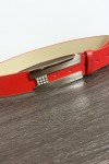 Red belt with rectangular buckle and rhinestones.