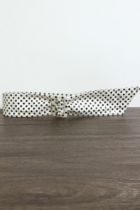 White faux leather belt with black weight.
