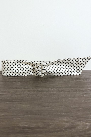 White faux leather belt with black weight.