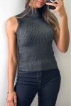 Short sleeveless black turtleneck sweater.