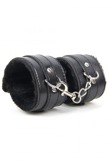 Pair of black faux leather handcuffs with faux fur